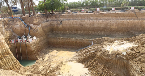 Comprehensive Dewatering Solutions - Excavated site with water and machinery